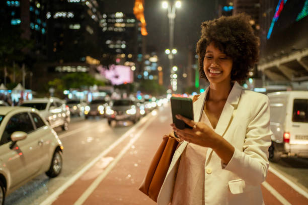 Portrait of woman with smartphone at Avenida Paulista, São Paulo, Brazil. stock photo