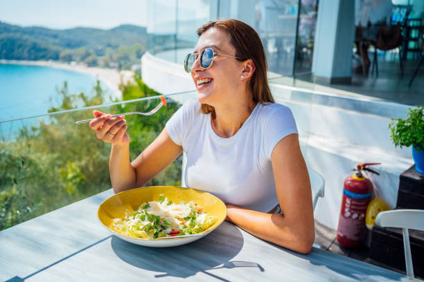 istock Woman having meal in a restaurant with view 1396325756