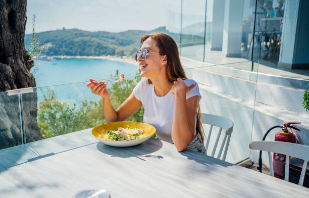 istock Woman having meal in a restaurant with view 1396325848