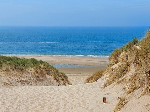view of the North Sea seen between the sand dunes between Castricum and Egmond.