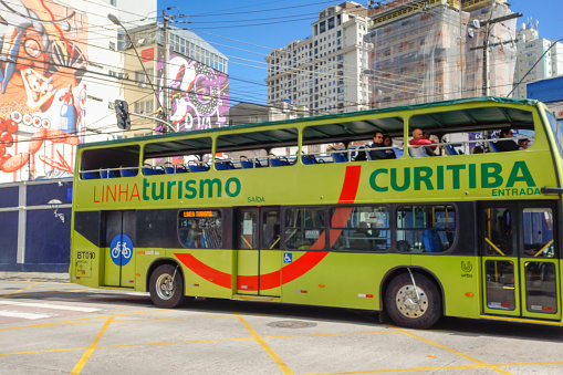 Curitiba, Parana: touristic bus riding passengers on city streets.