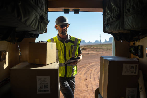 istock Delivery man getting packages out of his van 1396328528