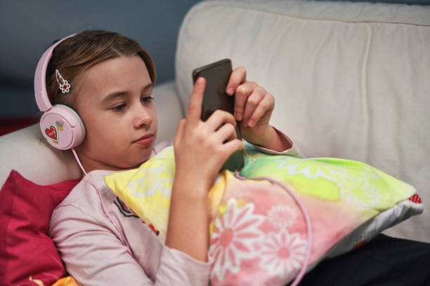 istock Little Girl Having Fun with her Smartphone 1396328536