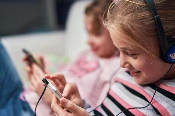 istock Little Girls Having Fun with their Smartphone 1396328599
