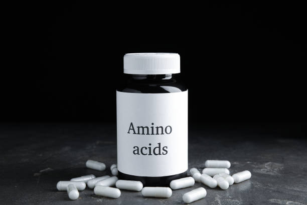 istock Amino acid pills and jar on grey table 1396329156
