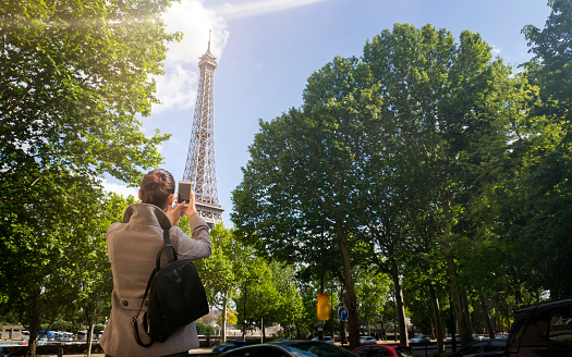 Female tourist make photo of Eiffel tower
