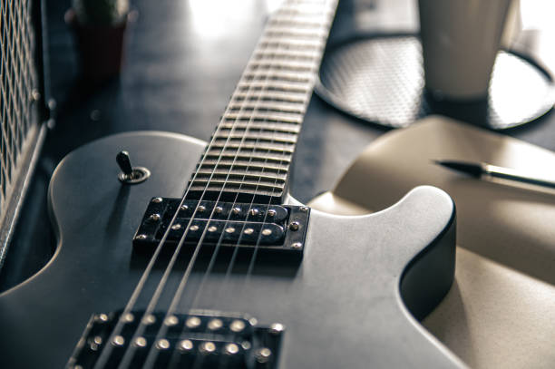 istock Close-up, electric guitar and notepad, concept of musical creativity. 1396331911