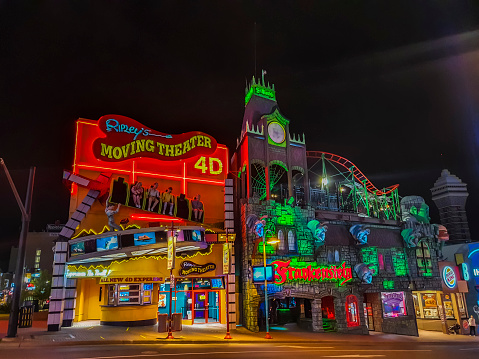 Niagara Falls, Ontario, Canada - September 24, 2020:  On Clifton Hill Street at Niagara Falls, you can see Ripley's Moving Theatre 4D, Frankenstein, Burger King,  Beavertails, a part of the IHOP, Applebees and casino. On the street you can see one person.