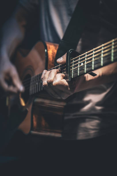istock A man plays an acoustic guitar, close-up. 1396335536