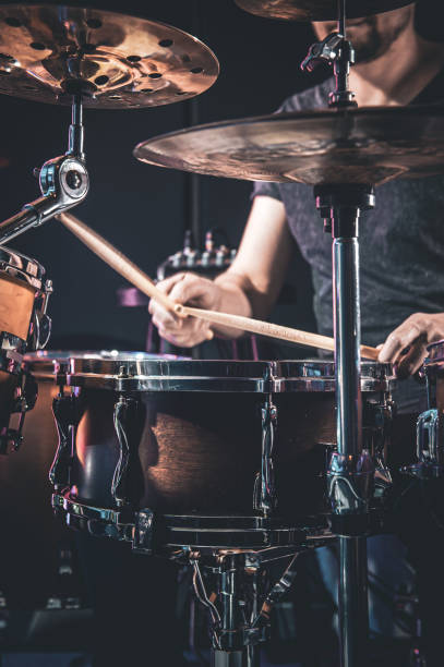 istock A male drummer plays the drums in a dark room. 1396335549