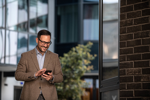 Businessman texting on mobile phone