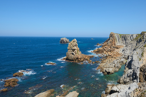 A beautiful view of whimsical rock formations on cliffs in northern Spain.