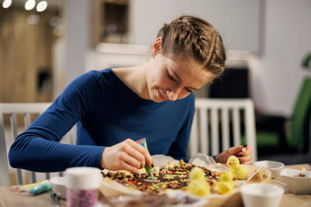 Teenagers decorating Easter tart cakes