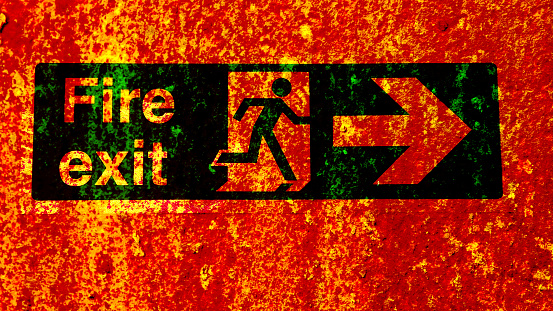 Exit text sign. Arrow red pointer exit. Emergency exit from building, wall texture.