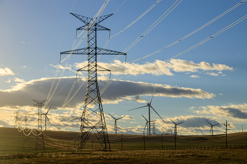 Electricy transmission metal utility pole power infrastructure in the Canadian prairies in Alberta, Canada.