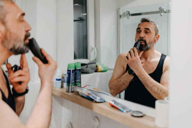 istock Handsome mature man shaving in bathroom 1396344551