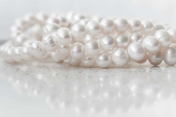 istock Nature white string of pearls on marble background in soft focus 1396351548