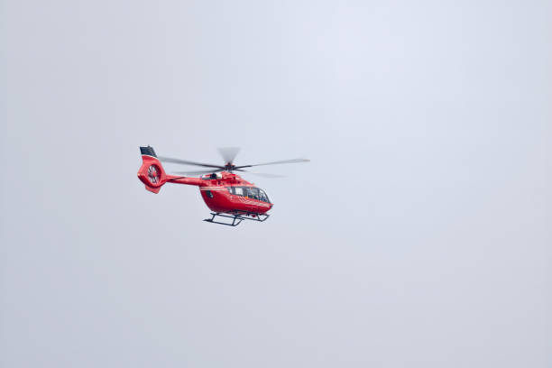 istock An Emergency red helicopter flying on the sky on a cloudy day. 1396352461