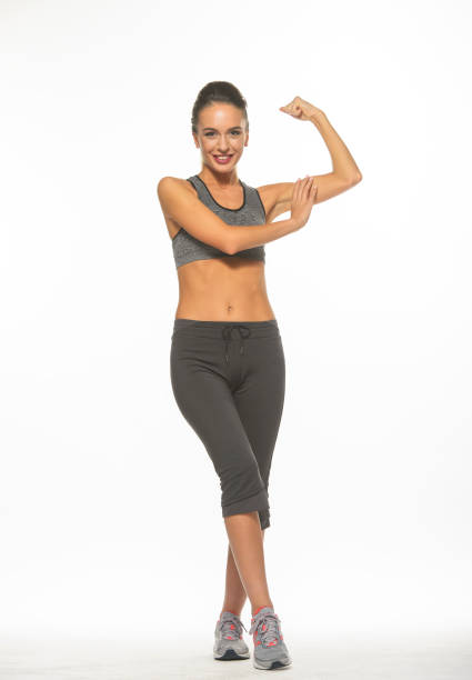 istock athletic girl in training clothes posing on a white background in the studio in full growth 1396352681