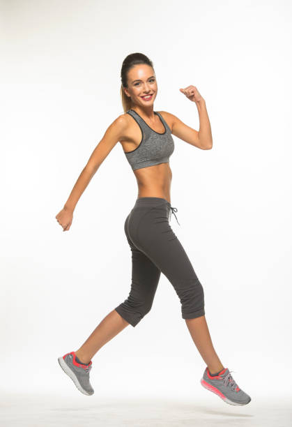 istock athletic girl in training clothes posing on a white background in the studio in full growth 1396352703