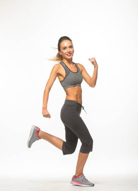 istock athletic girl in training clothes posing on a white background in the studio in full growth 1396352710