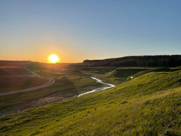 istock green hills with a clear stream at sunset 1396353322