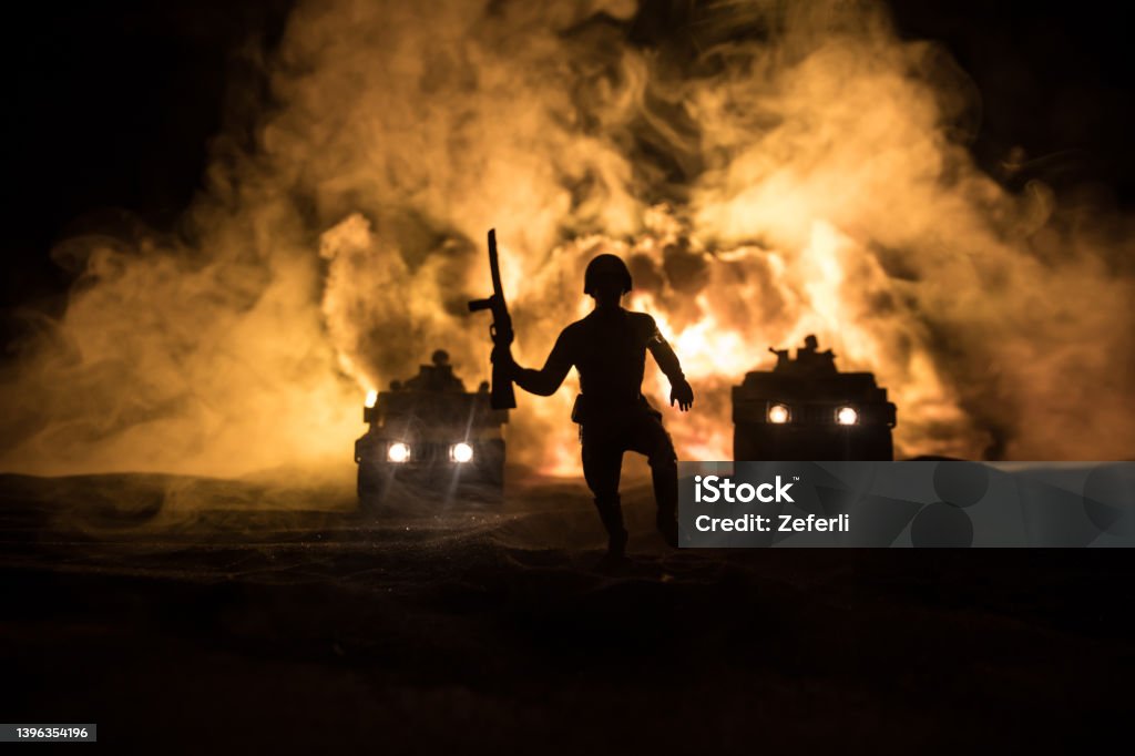 War Concept. Battle scene on war fog sky background, Fighting silhouettes Below Cloudy Skyline at night. Army vehicle with soldiers artwork decoration. Selective focus War between Russia and Ukraine. Battle scene on war fog sky background, Fighting silhouettes Below Cloudy Skyline at night. Army vehicle with soldiers artwork decoration. Selective focus Army Stock Photo