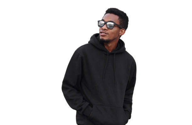 Portrait of stylish young african man looking away wearing black hoodie, sunglasses isolated on white background stock photo