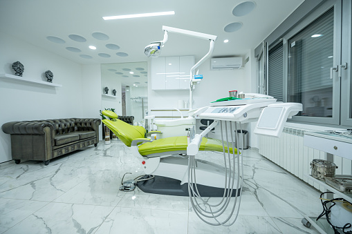 Interior of white modern dentistry medical room with special equipment. Dentist office. Dental clinic interior with modern dentistry tools.
