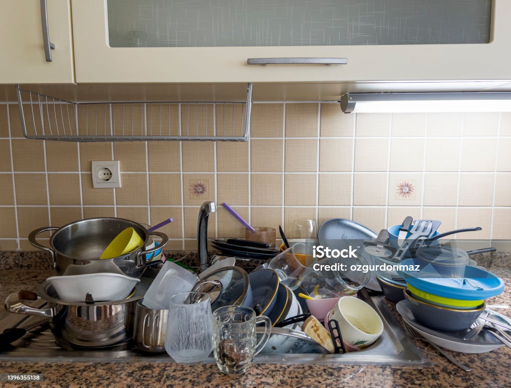 Close up view of dirty dishes in the sink in the kitchen Sink Stock Photo