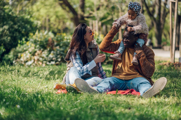 istock Multiracial family having fun in the park 1396355210