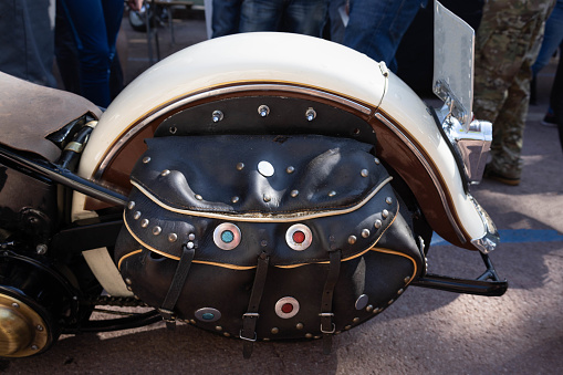 nostalgic red motorcycle helmet lies on the seat of the motorcycle