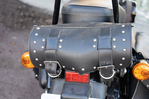 Leather vintage  black saddlebags for Harley in the back of the motorbike to keep the luggage to go to an exhibition