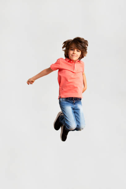 istock Young boy jumping in the air 1396358169