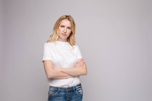 istock Angry or sad girl with folded arms. 1396361544