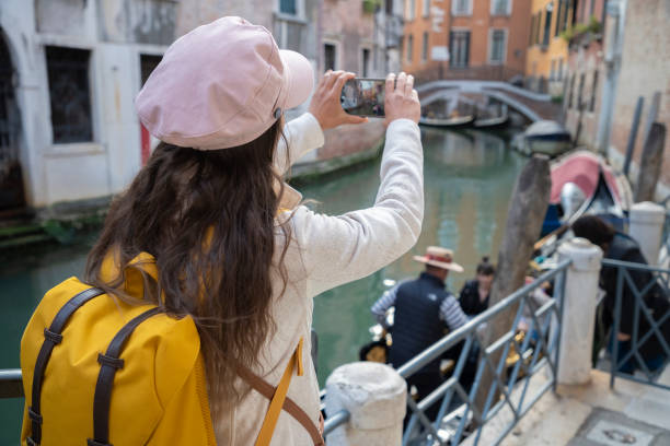 istock Woman discovers Venice on vacation at dusk. 1396362174