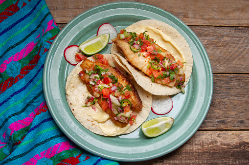 Fish tacos with fresh sauce and mayonnaise. Traditional mexican food