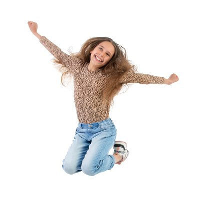Excited Teen girl Jumping against White background
