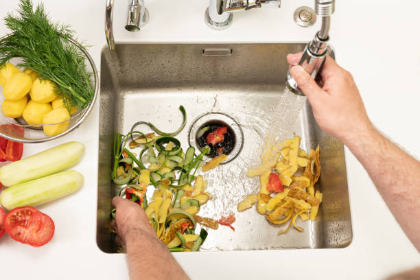 istock Food waste after peeling vegetables is destroyed using the Disposer 1396367258