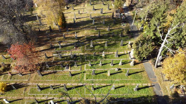 Arial drone view flight over old cemetery with tombstones, gravestones, arrows