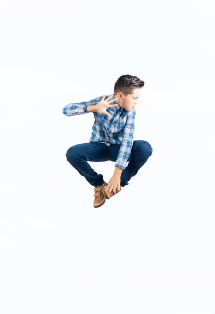 Full length photo of cheerful boy jumping up isolated on aquamarine blue color background.