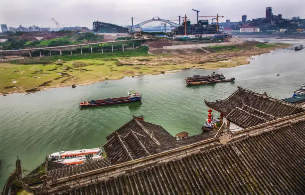 River Boats Jialing River Chinese buildings factories Chongqing Sichuan China Jialing flows into Yangtze River