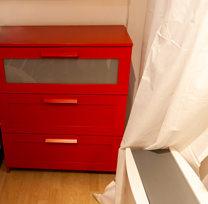 red bedside table.Chest of Drawers
