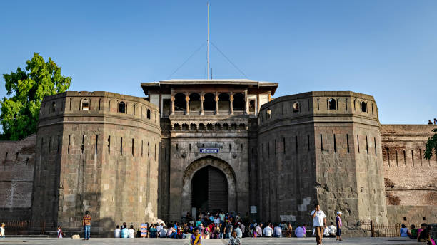 Crowd in front of historical monument in Pune. Pune, Maharashtra, India-May 26th, 2016:Crowd in front of historical monument  in Pune. Text in local language is name "Shaniwar Wada". pune photos stock pictures, royalty-free photos & images