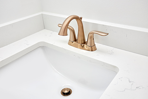 Gold color bathroom sink with faucet