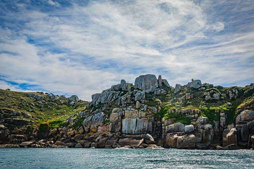 Stone rock mountain forest seascape in Cruising tour view in the Bass Strait at Wilson Promontory Victoria Australia, blue sky and blue sea