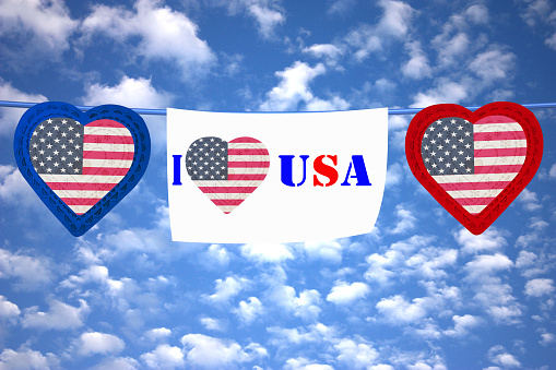 I Love USA  Garland of pennants with drawings of hearts on bright sky background