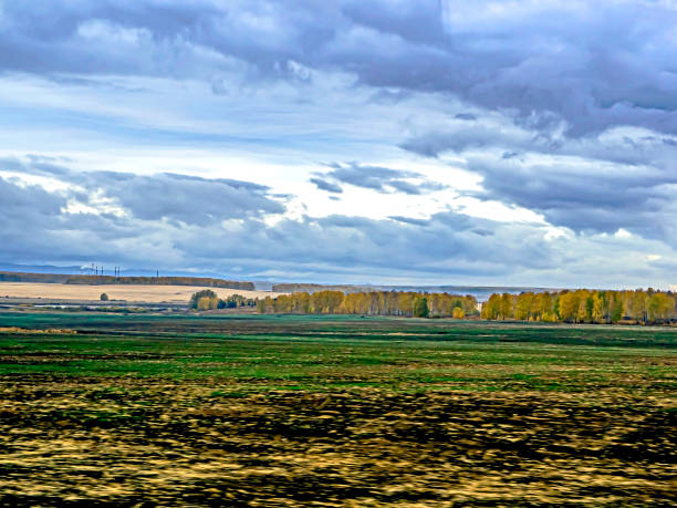 beautiful golden autumn in the southern Urals beautiful golden autumn in the southern Urals, unfocused landscape along the road in the early morning on a cloudy day, typical South Ural landscapes, resembles a watercolor drawing south ural stock pictures, royalty-free photos & images