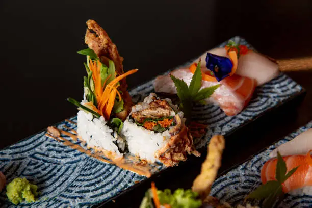 Kaiseki sushi platter combo set on the serving board in the fine dining Japanese restaurant, sashimi, nigiri and raw fish
