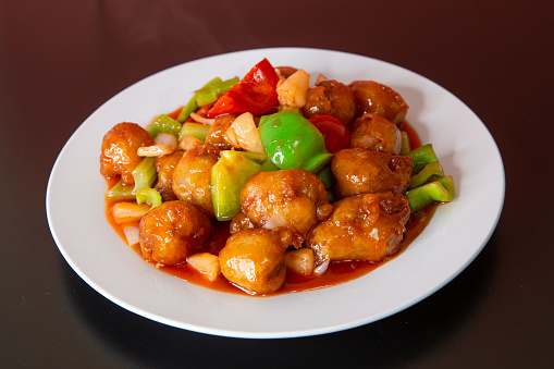 oriental chicken with almonds, chinese traditional food on white plate